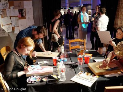 Several people painting at tables